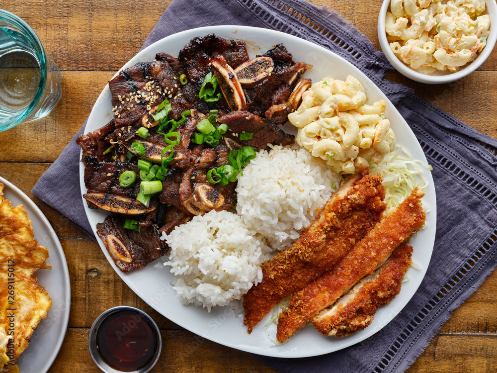 hawaiian bbq plate with mix of chicken katsu, korean kalbi beef short ribs, rice, and macaroni salad overhead composition hawaiian bbq plate with mix of chicken katsu, korean kalbi beef short ribs, rice, and macaroni salad overhead composition