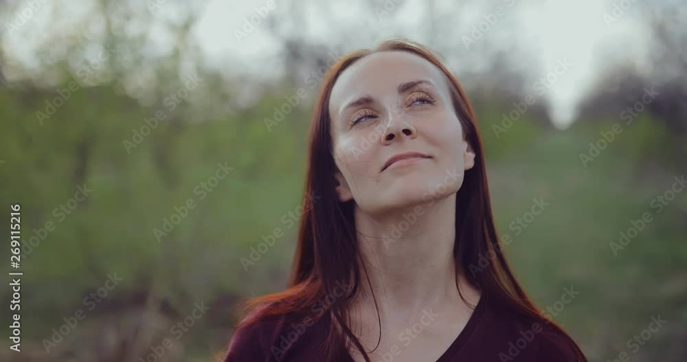 Beautiful girl stands with closed eyes and enjoys nature. Portrait view. Beautiful girl stands with closed eyes and enjoys nature. Portrait view.