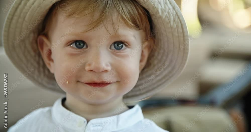 A cute little baby happily smiling. Caucasian child eating something tasty - extreme close up 4k A cute little baby happily smiling. Caucasian child eating something tasty - extreme close up 4k