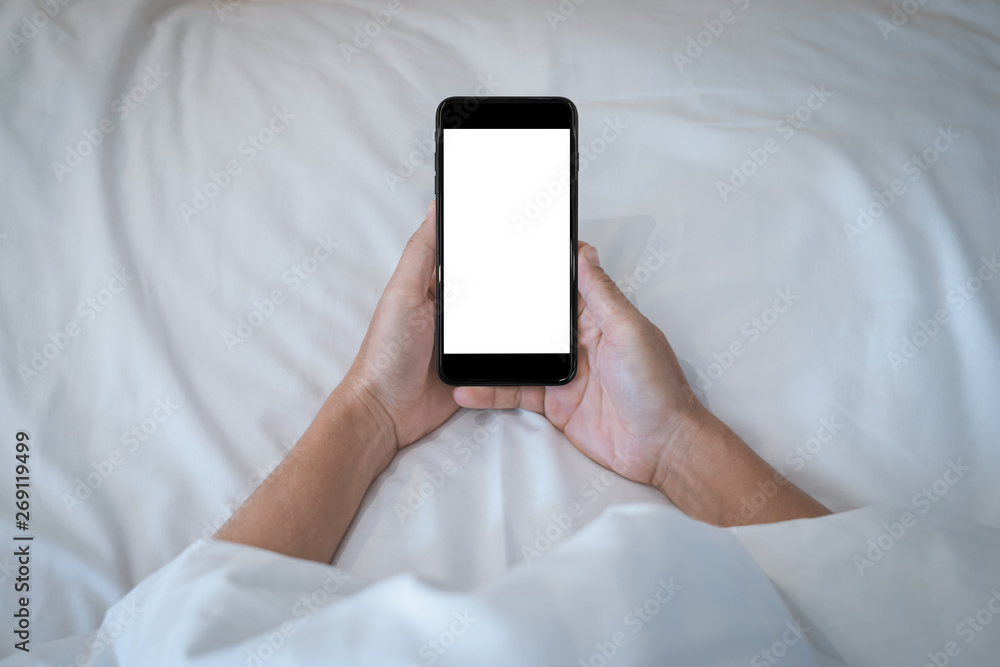 Woman holding on her smartphone while sleeping in bed background. Woman holding on her smartphone while sleeping in bed background.