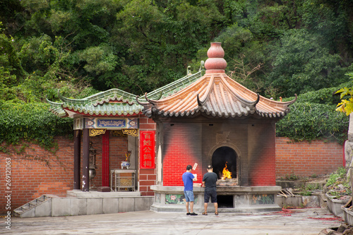 People burn joss paper and burned as sacrificial offering for pray to god and memorial to ancestor in Tiantan temple at Shantou or Swatow in Chaozhou, China