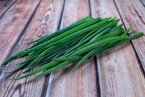 a bunch of fresh green onions lying on the table
