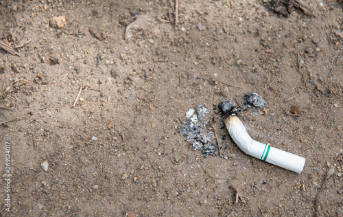 Men smoke in the park. Tobacco that is quenched and placed on the ground.