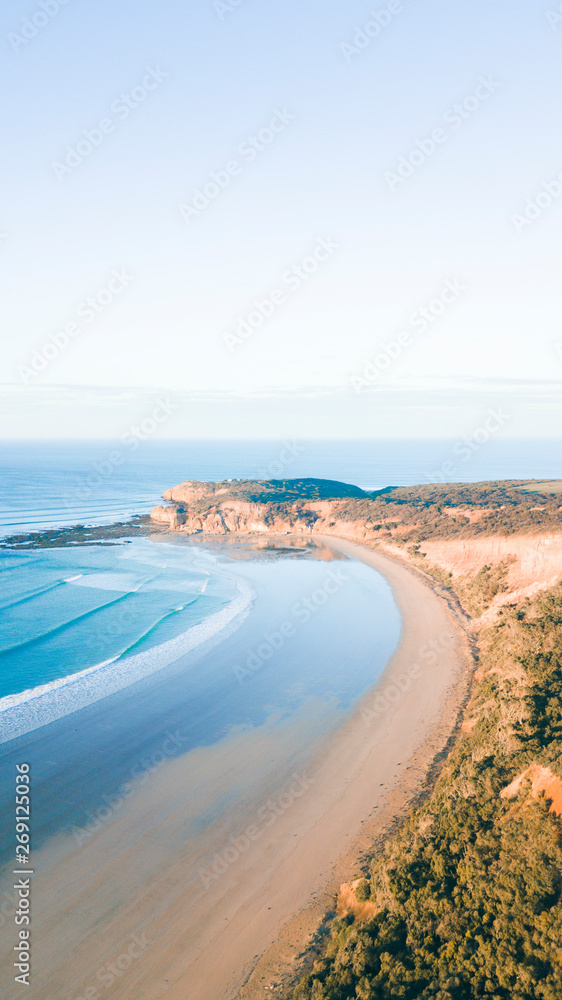 Aerial View of Beautiful Beach Coastline with Person on top of Cliffs Along the Great Ocean Road Australia