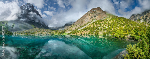 Tourism in Tajikistan, lake in the Fan Mountains. Scenic summer view, panorama landscape. 
