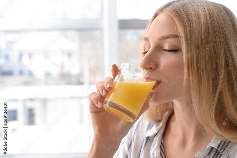 Beautiful young woman drinking fresh juice at home Beautiful young woman drinking fresh juice at home