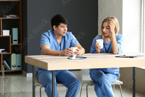 Young medical assistants having break during work in clinic