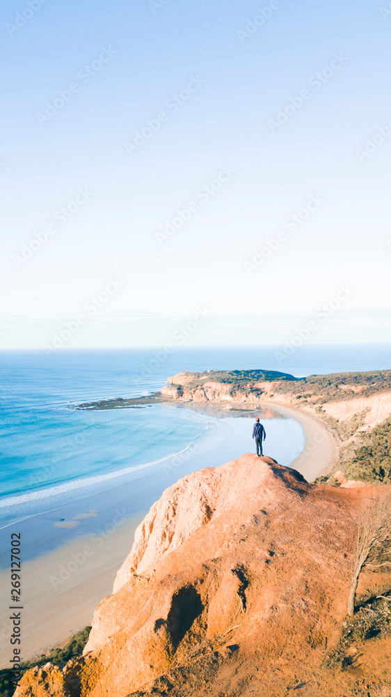 Aerial View of Beautiful Beach Coastline with Person on top of Cliffs Along the Great Ocean Road Australia
