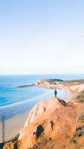 Obraz na płótnie Aerial View of Beautiful Beach Coastline with Person on top of Cliffs Along the Great Ocean Road Australia w salonie