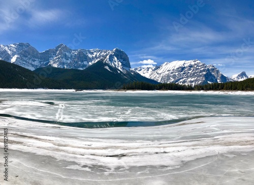 Snow covered mountain background with an icy lake  © Katherine BYC