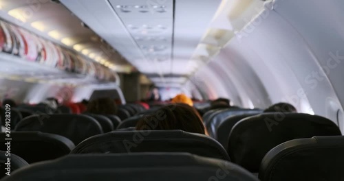POV of airplane interior in economy seat. Wide shot.