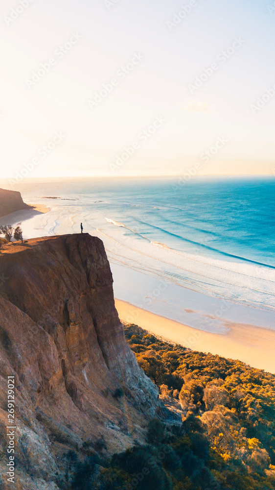 Aerial View of Beautiful Beach Coastline with Person on top of Cliffs Along the Great Ocean Road Australia