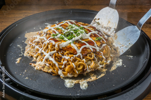 お好み焼き Okonomiyaki is a Japanese-style pancake