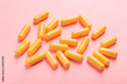 Yellow medical capsule and pills