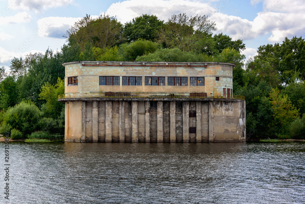Naklejka premium Old building by the river in summer.
