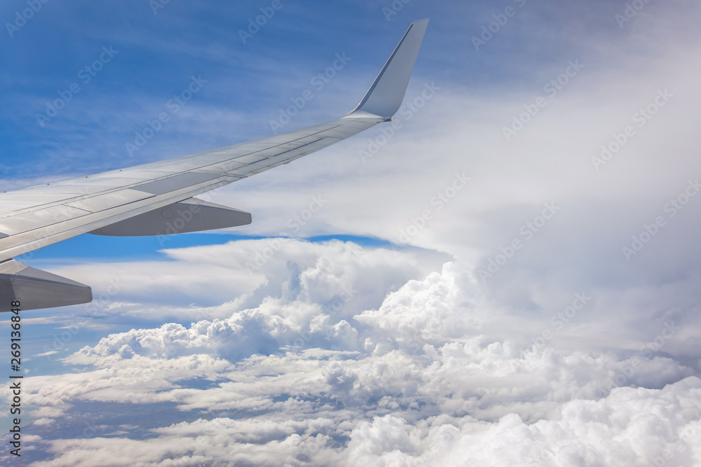 Wing of an airplane flying above the summer clouds. Wing of an airplane flying above the summer clouds.