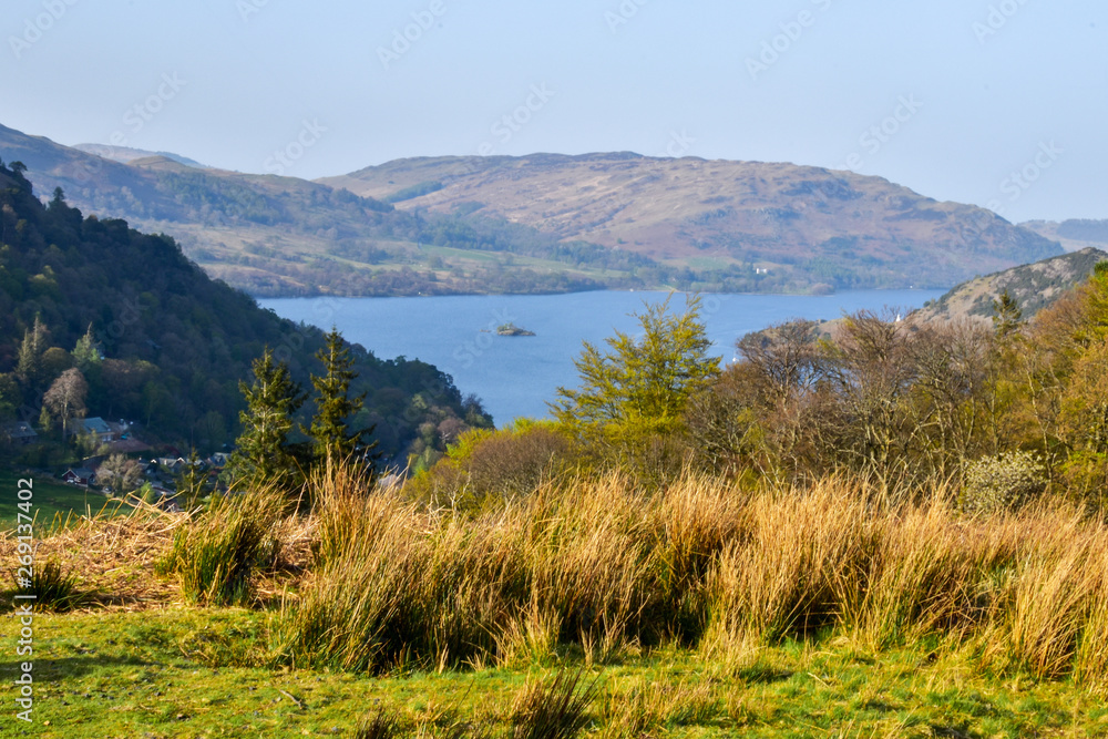 Beautiful view of Lake Windermere. Grassy hills in the foreground, mountains in the far background. Lake District, England, UK. -Image