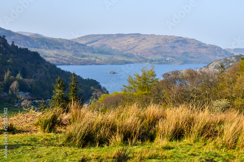 Beautiful view of Lake Windermere. Grassy hills in the foreground, mountains in the far background. Lake District, England, UK. -Image