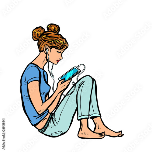 Teen girl listening to music or audiobook on the phone
