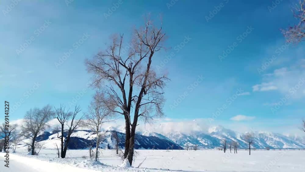Snow covered field with a mountain range in distance. Snow covered field with a mountain range in distance.