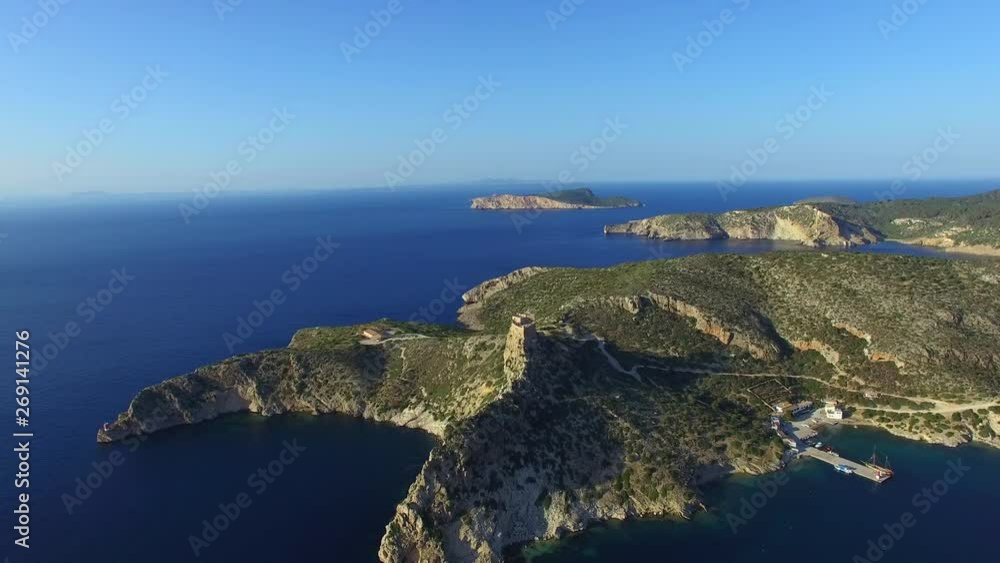 Revealing aerial shot of a protected bay full of sailing yachts at Isla de Cabrera, Spain,  on a beautiful sunny day.