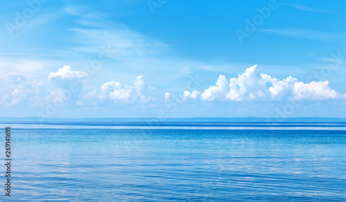 Natural background of blue water surface with reflection of clouds. Lake Baikal on a sunny summer day. Beautiful water landscape