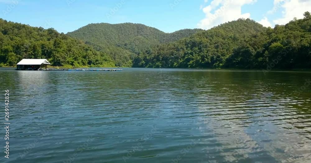 flying right above lake water surrounded by mountains at national park in Thailand flying right above lake water surrounded by mountains at national park in Thailand