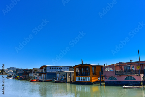 House boats floating on water on a sunny day in Sausalito, San Francisco bay, USA