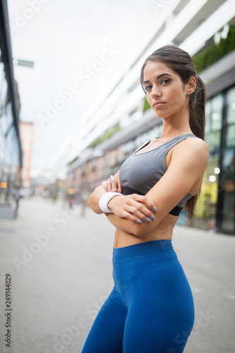 Beautiful happy fit woman running and exercising outdoor