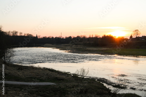 Beautiful countryside river view with amazing sunset in the background.  © Artūrs Stiebriņš