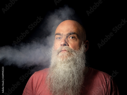 bearded man gets smoke in his face portrait