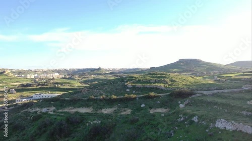 4K Ariel view of mountain scape in Malta, top view. The unique urban structure and green agricultue terrace photo