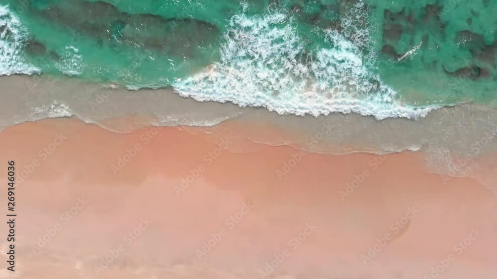 Aerial shot of white sand beach and turquoise ocean water in Oman, near Salalah. Arabian Peninsula
