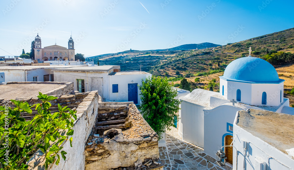 Typical whitewashed church with blue dome on the corner of the street, Lefkes, Paros island, Greece - obrazy, fototapety, plakaty 