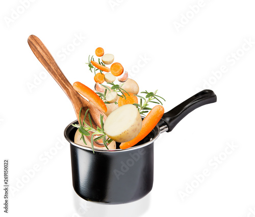 Frying pan with flying vegetables, isolated on white backfground – image photo