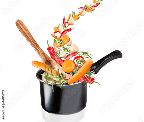 Frying pan with flying vegetables, isolated on white backfground – image photo