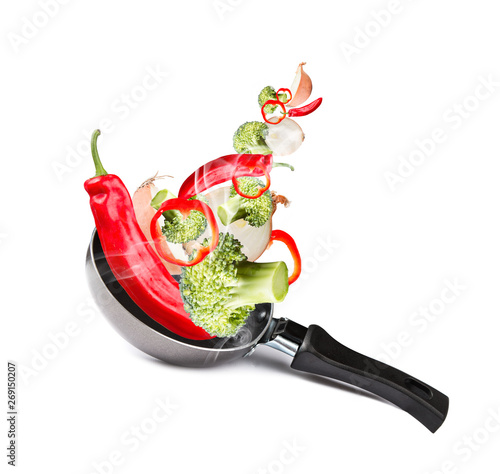 Frying pan with flying vegetables, isolated on white backfground – image photo