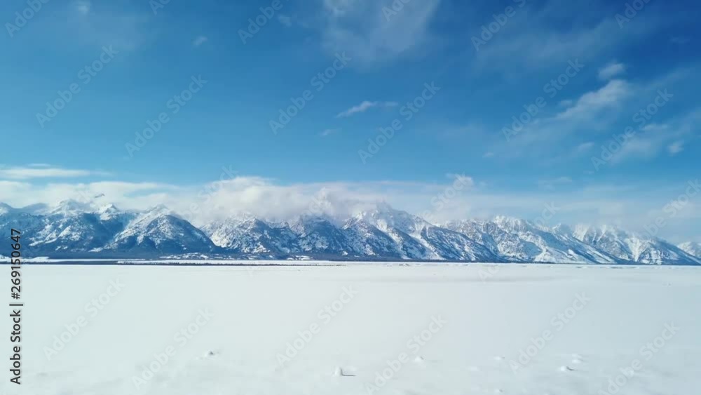 Mountain range across a snowy field Mountain range across a snowy field