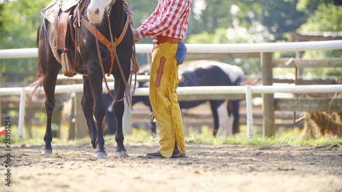 Cowboy preparing the horse