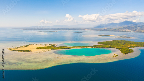 Tropical island with mangroves and turquoise lagoons on a coral reef  top view. Fraser Island  seascape Honda Bay  Philippines. Atolls with lagoons and white sand.