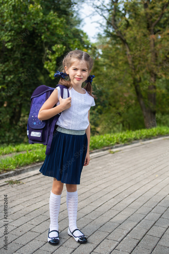 beautiful school girl with schoolbag in park, concept September 1 and back to school beautiful school girl with schoolbag in park, concept September 1 and back to school