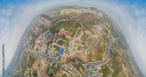 Aerial view above Khao Ngu Stone Park Rock Mountain, reservoir, high way and rice fields with cloudy sky background, Ratchaburi, Thailand. Pola Graphic Design Earth Concept.