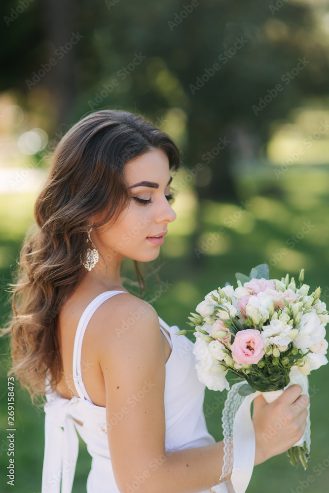 Portrait of yound girl with bouquet. Charming lady in sunny summer day. Stylish woman Portrait of yound girl with bouquet. Charming lady in sunny summer day. Stylish woman