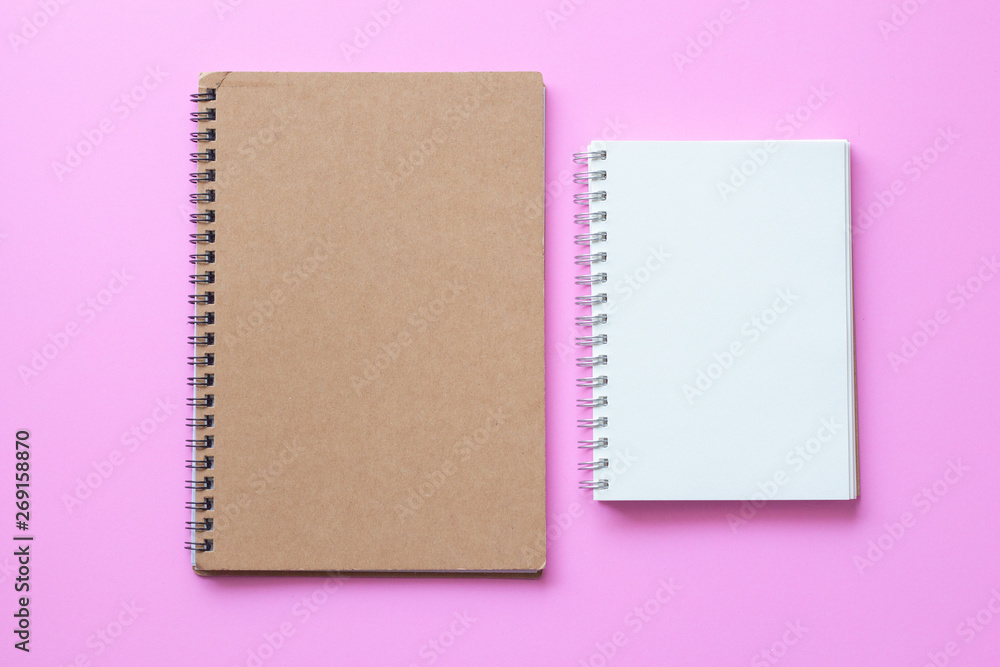 Fototapeta premium brown cover notebook with open blank paper notebook on pink background. 