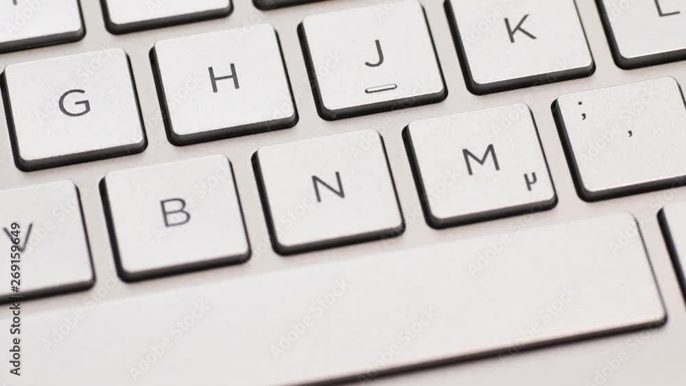 Metal laptop keyboard with german layout, macro shot with tilt. Metal laptop keyboard with german layout, macro shot with tilt.