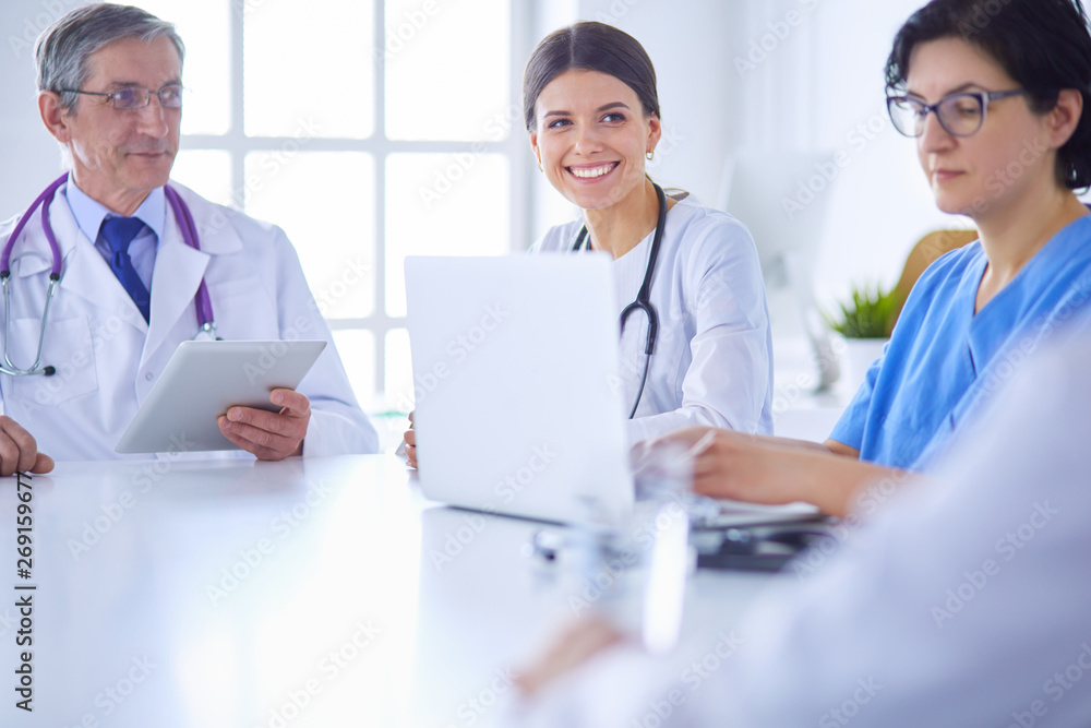 Serious medical team discussing patient's case in a bright office Serious medical team discussing patient's case in a bright office