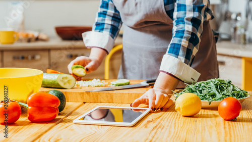 Food recipe. Electronic cookery book. Healthy diet. Croped shot of woman using modern technology to explore new cuisines.