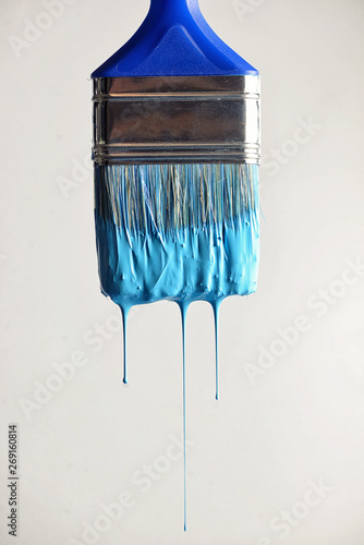 Dripping blue paint from brush