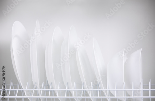 Row of clean white plates in the closet