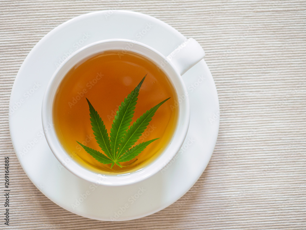 tea with marijuana. Cannabis leaf is brewed in herbal decoction to treat pain and increase appetite. concept of marijuana use for medicinal purposes. tea with marijuana. Cannabis leaf is brewed in herbal decoction to treat pain and increase appetite. concept of marijuana use for medicinal purposes.